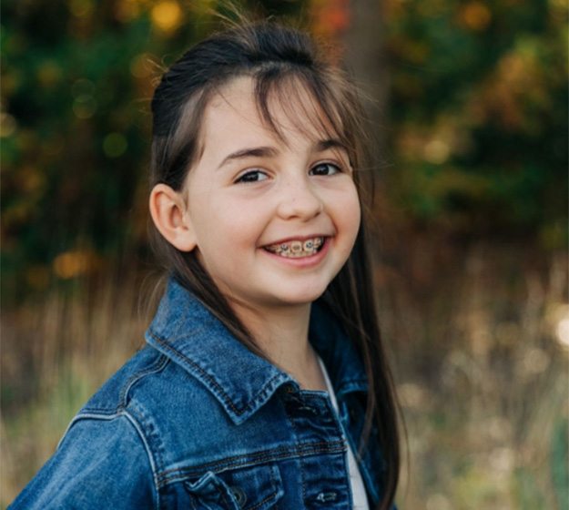 a person smiling with a missing tooth