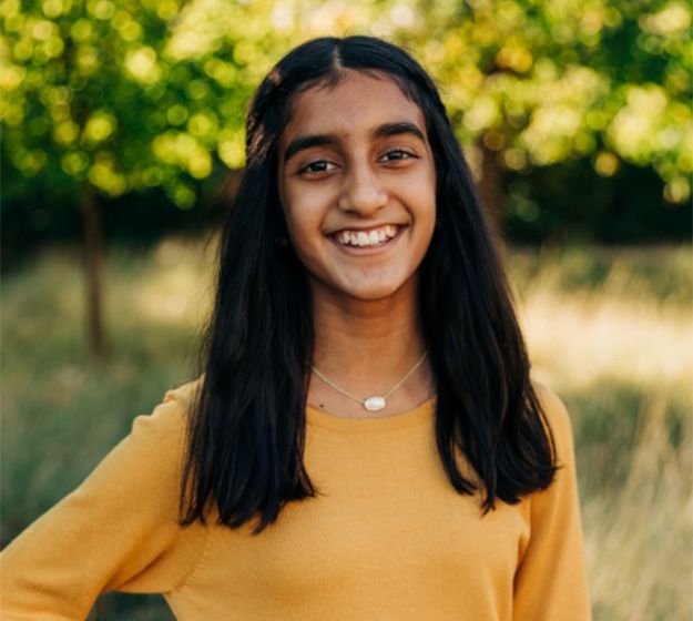 Girl’s smile with clear braces and tooth-colored wire