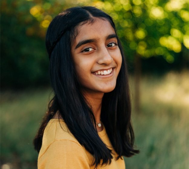 a person smiling and wearing braces