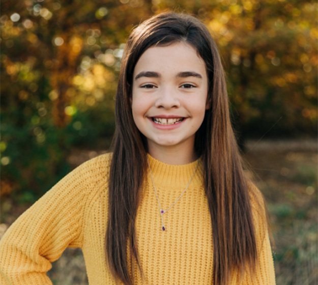 An up-close image of metal braces on a child’s upper and lower teeth