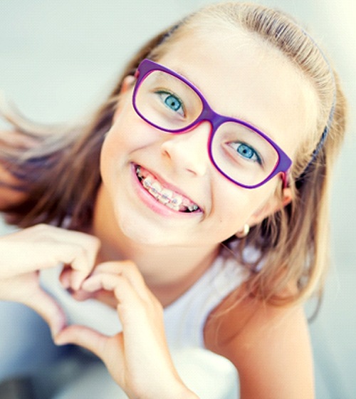 Young girl with braces from Aetna orthodontist in Richardson