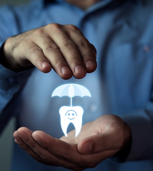 Man holding umbrella over tooth