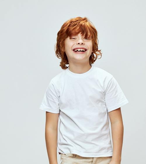 Portrait of smiling child in white t-shirt