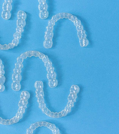 Invisalign aligners against blue background