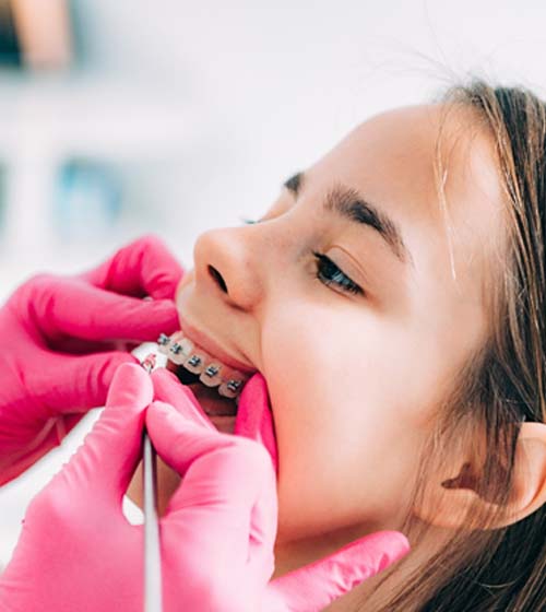 Orthodontist in Richardson checking patient’s smile