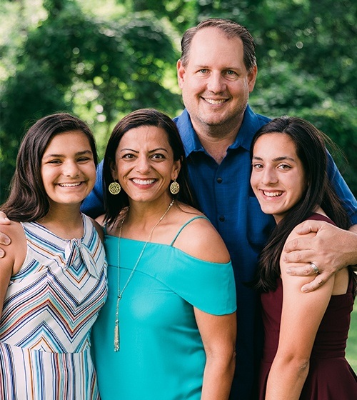 Family of four with healthy smiles thanks to orthodontics