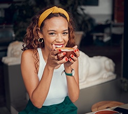 Woman smiling while working on laptop