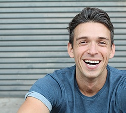 young man smiling outside