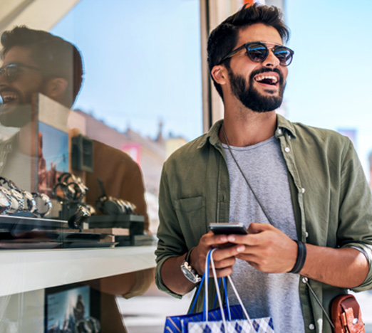 Man smiling while shopping outside