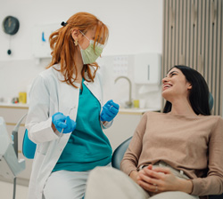 Smiling patient talking to dentist in treatment chair