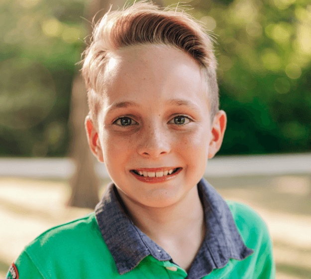 Young boy smiling after receiving phase 1 orthodontics
