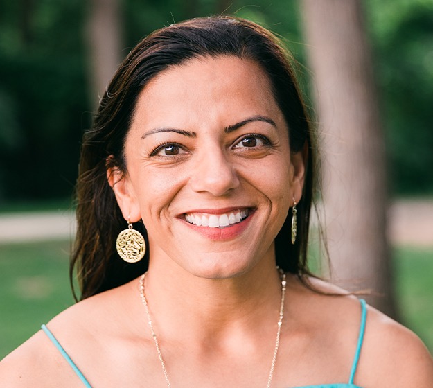 Adult woman showing off beautiful smile after orthodontics