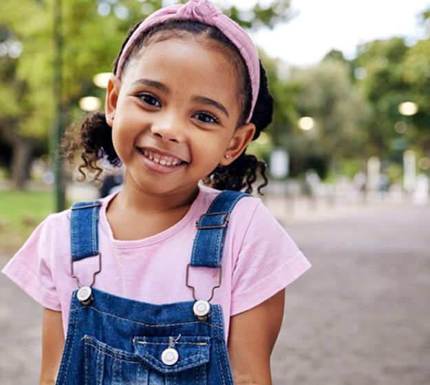 happy young girl standing outside