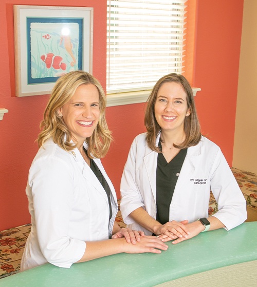 Actual patient with traditional braces smiling with her mom