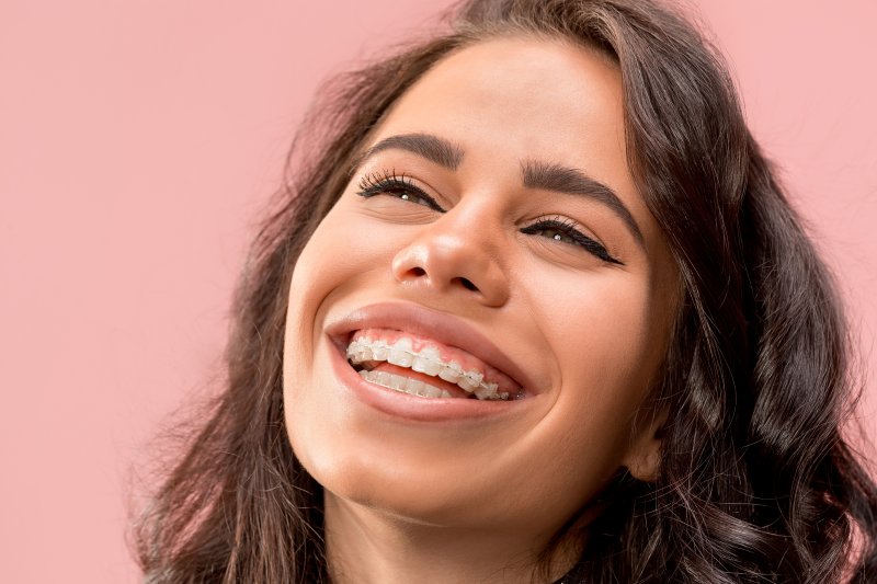 Closeup of woman smiling with metal braces