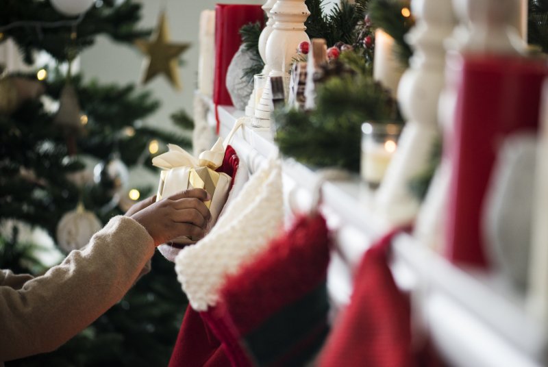 person putting stocking stuffers in stockings