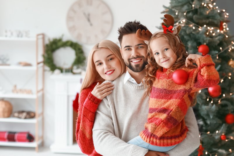 young family smiling on Christmas