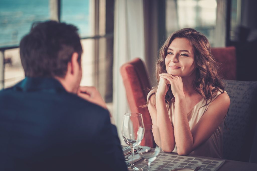 Woman smiling on date in restaurant