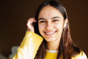 Smiling person wearing braces