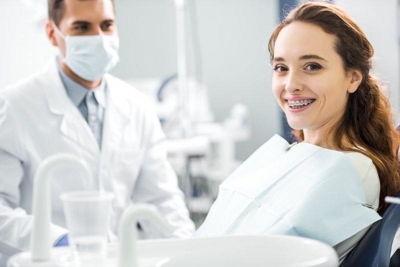 Patient smiling after dealing with orthodontic emergencies