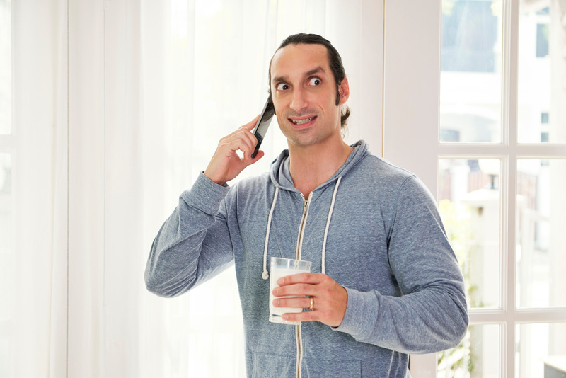 Invisalign patient cringing while on the phone