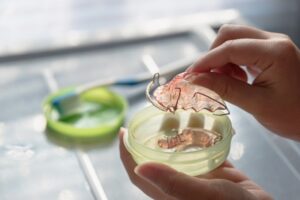 Person putting their retainer in its case